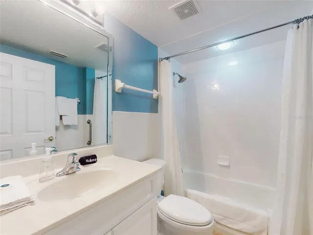 a bedroom with a bed and a night stand