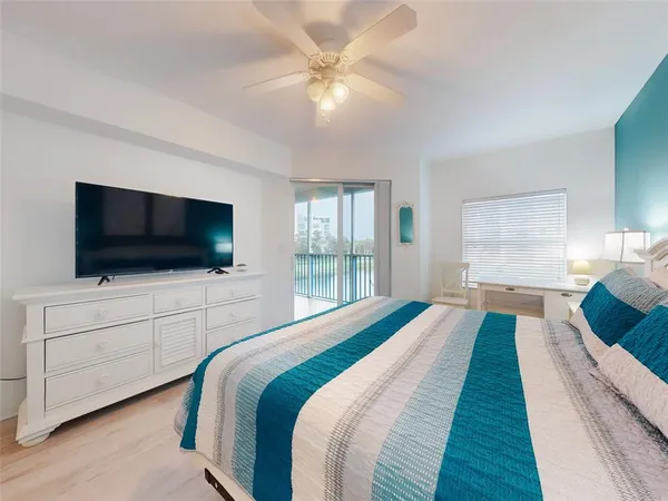 a view of a swimming pool with outdoor seating and a potted plant