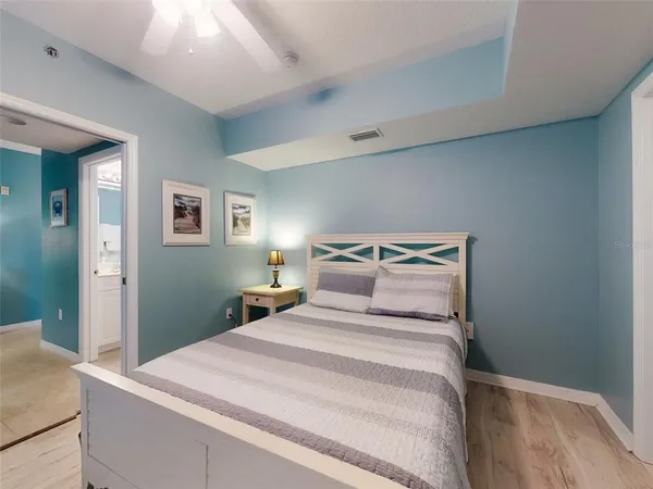 a bedroom with a bed and a chandelier