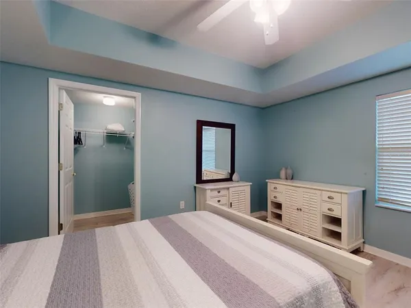 a view of a dining room with furniture and a chandelier fan