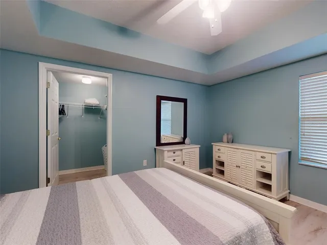 a view of a dining room with furniture and a chandelier fan