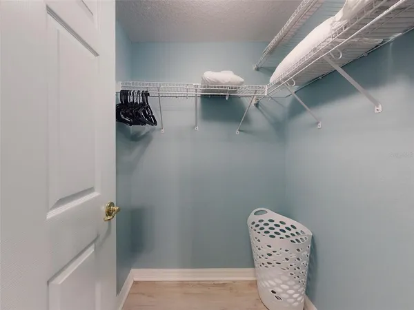 a dining room with furniture and a chandelier fan