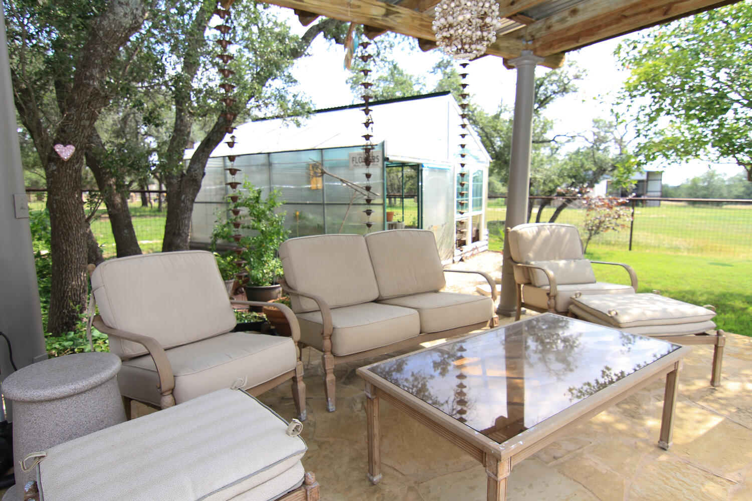 219 Young Ranch Road Georgetown, TX 78633 - Photo 13 of 40 View of patio / terrace with outdoor lounge area, an outdoor structure, and a greenhouse
