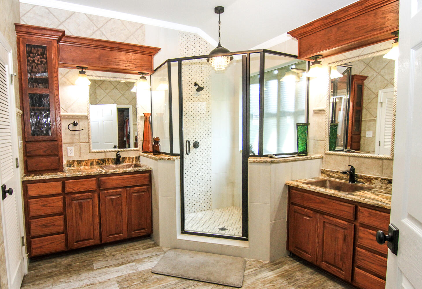 219 Young Ranch Road Georgetown, TX 78633 - Photo 29 of 40 Full bath featuring a shower stall, two vanities, tile walls, and crown molding