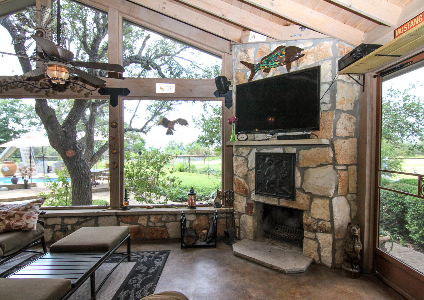 219 Young Ranch Road Georgetown, TX 78633 - Photo 6 of 40 Screened patio with stone fireplace and finished concrete floors