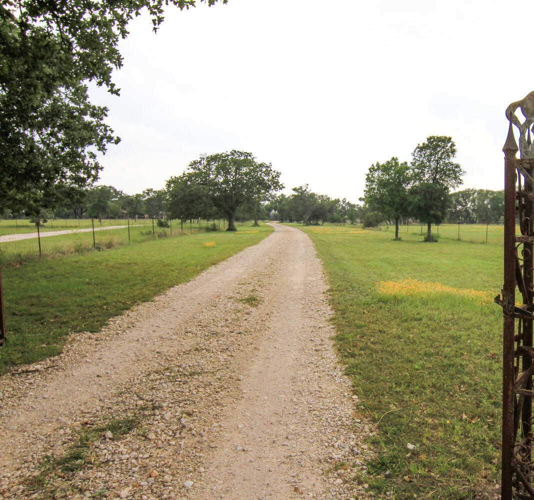219 Young Ranch Road Georgetown, TX 78633 - Photo 10 of 40 View of front entry of drive featuring a view of rural / pastoral area