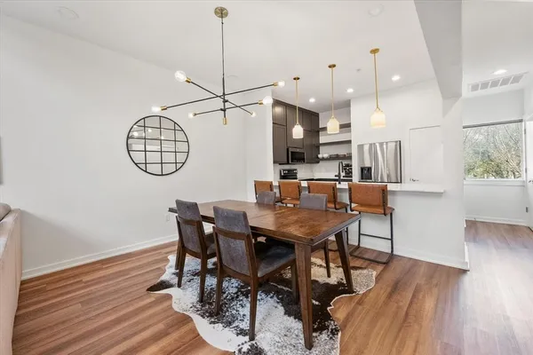a view of a dining room with furniture window and wooden floor