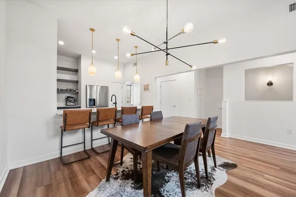 a view of a dining room with furniture window and wooden floor