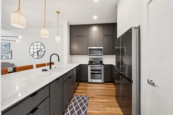 a view of a dining room with furniture and a flat screen tv