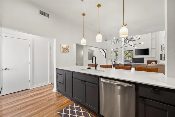 a kitchen with stainless steel appliances a refrigerator sink and cabinets