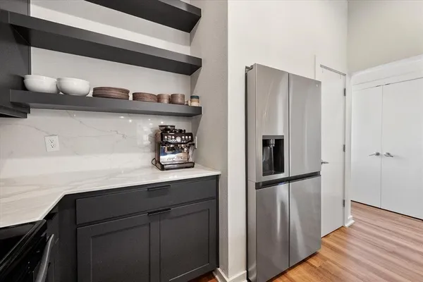 a kitchen with stainless steel appliances a stove a sink and a wooden floor