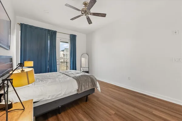 a bedroom with a bed and wooden floor