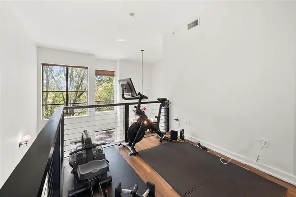 a bed room with a bed couches and a flat tv screen