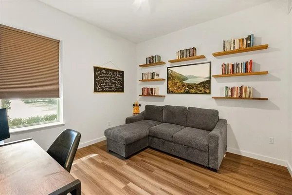 a living room with furniture and a book shelf