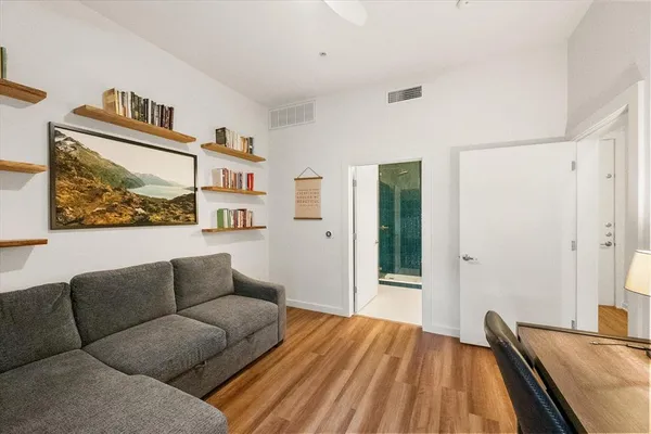 a living room with furniture and a wooden floor