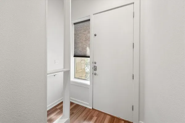 a view of front door with wooden floor