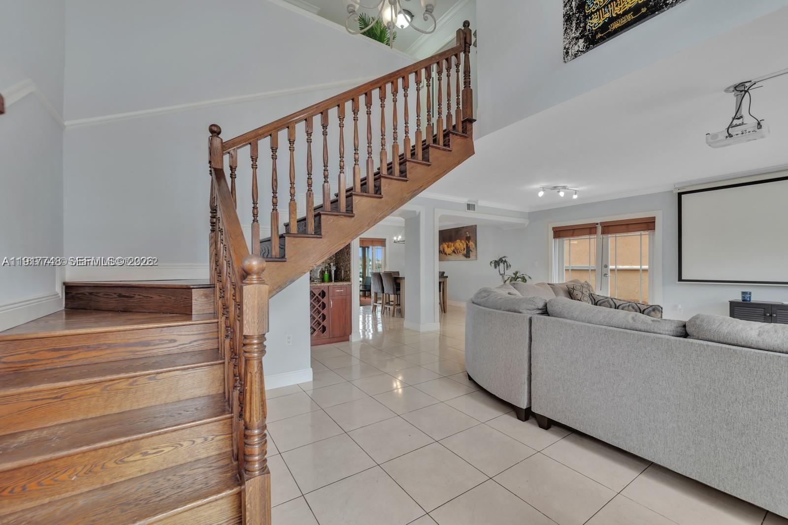 815 Northwest 126th Court Miami, FL 33182 - Photo 11 of 20 a living room with furniture and a flat screen tv