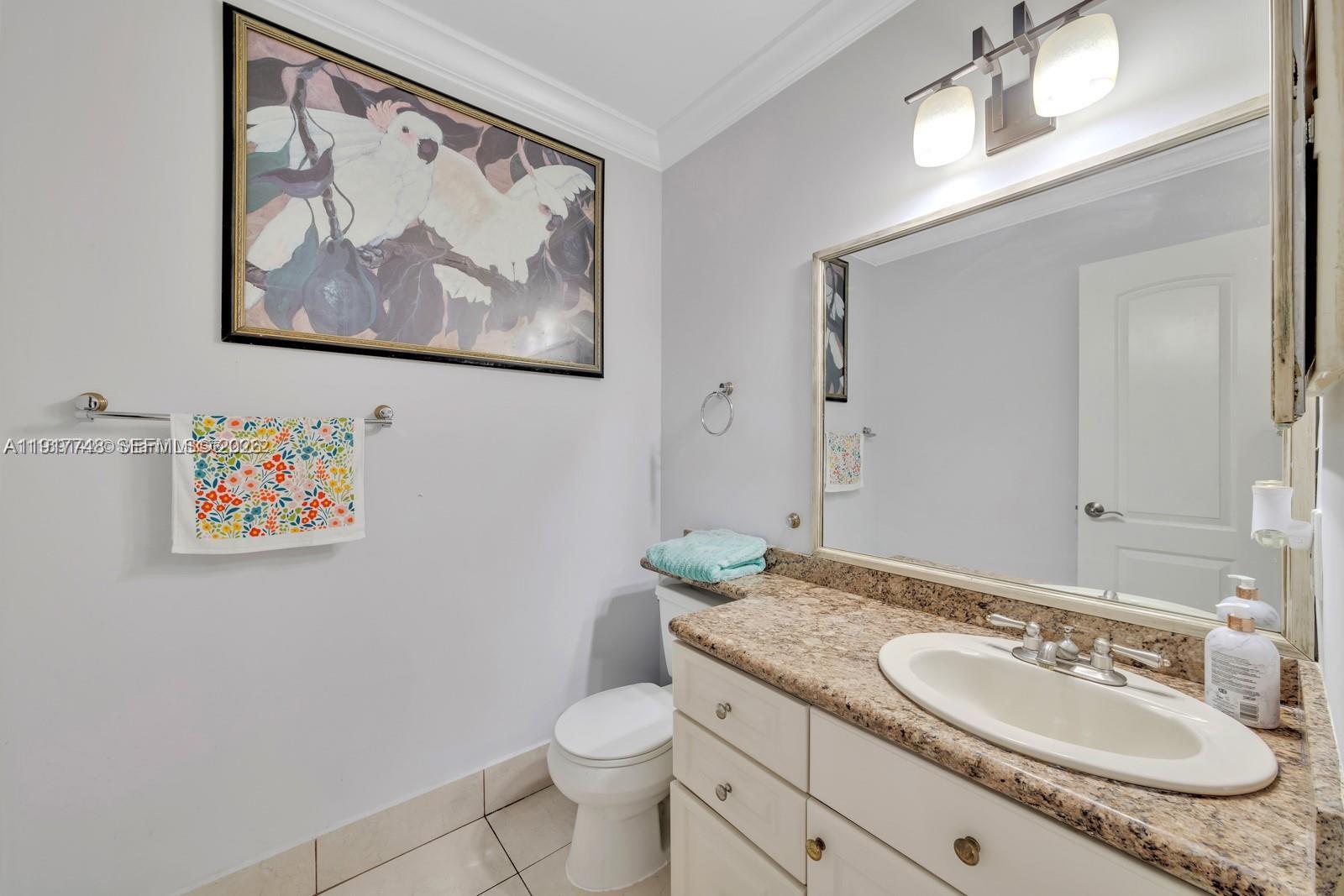 815 Northwest 126th Court Miami, FL 33182 - Photo 14 of 20 a bathroom with a granite countertop sink and a mirror