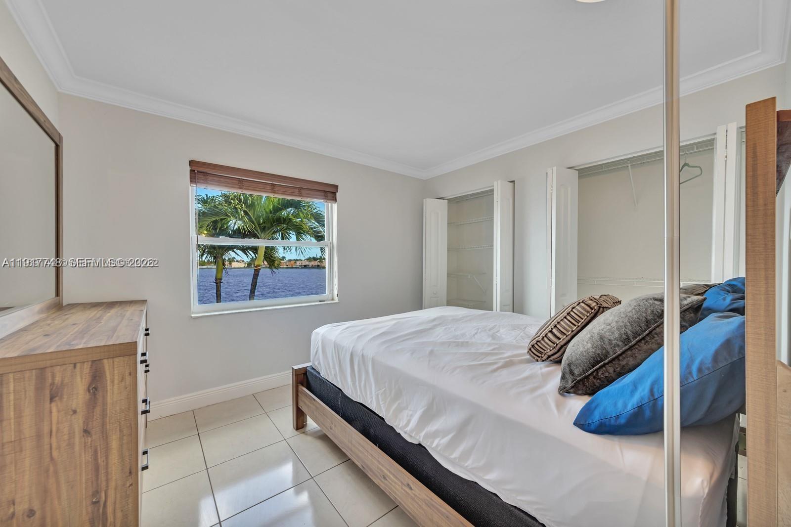 815 Northwest 126th Court Miami, FL 33182 - Photo 15 of 20 a bedroom with a bed and a window