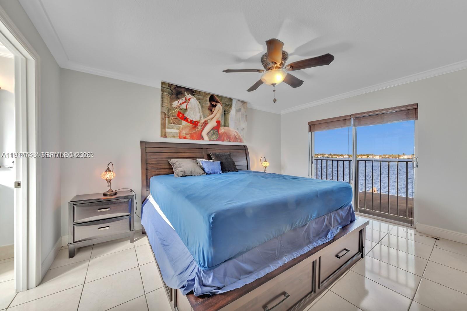 815 Northwest 126th Court Miami, FL 33182 - Photo 18 of 20 a bedroom with a bed and a chandelier