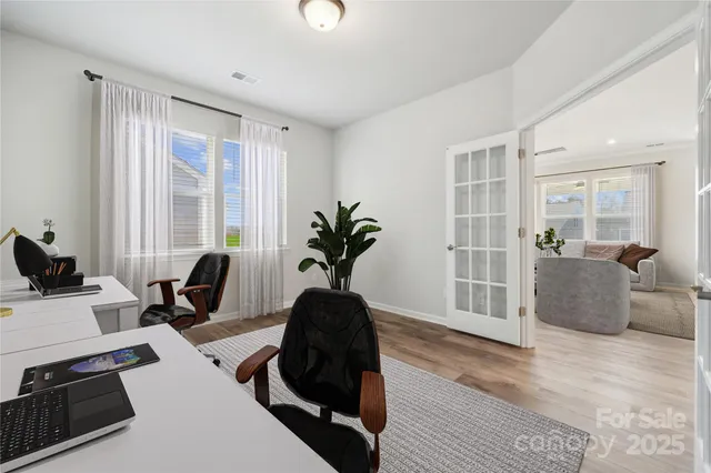 a view of a workspace with furniture and a potted plant