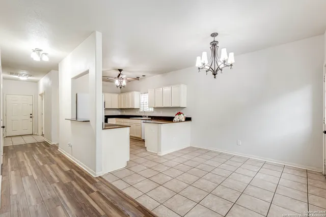 a view of kitchen and hallway with chandelier