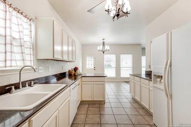 a kitchen with a sink a counter top space cabinets and stainless steel appliances