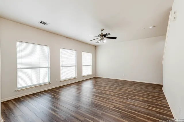 wooden floor in an empty room with a window