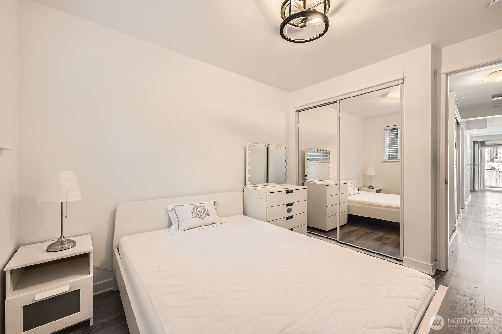 701 122nd Avenue Northeast, Unit 102 Bellevue, WA 98005 - Photo 11 of 14 a bedroom with a bed and a chandelier