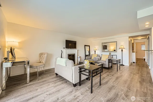 a living room with fireplace furniture and a wooden floor