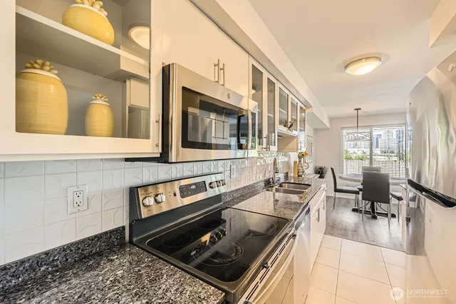 a kitchen with stainless steel appliances granite countertop a sink and cabinets