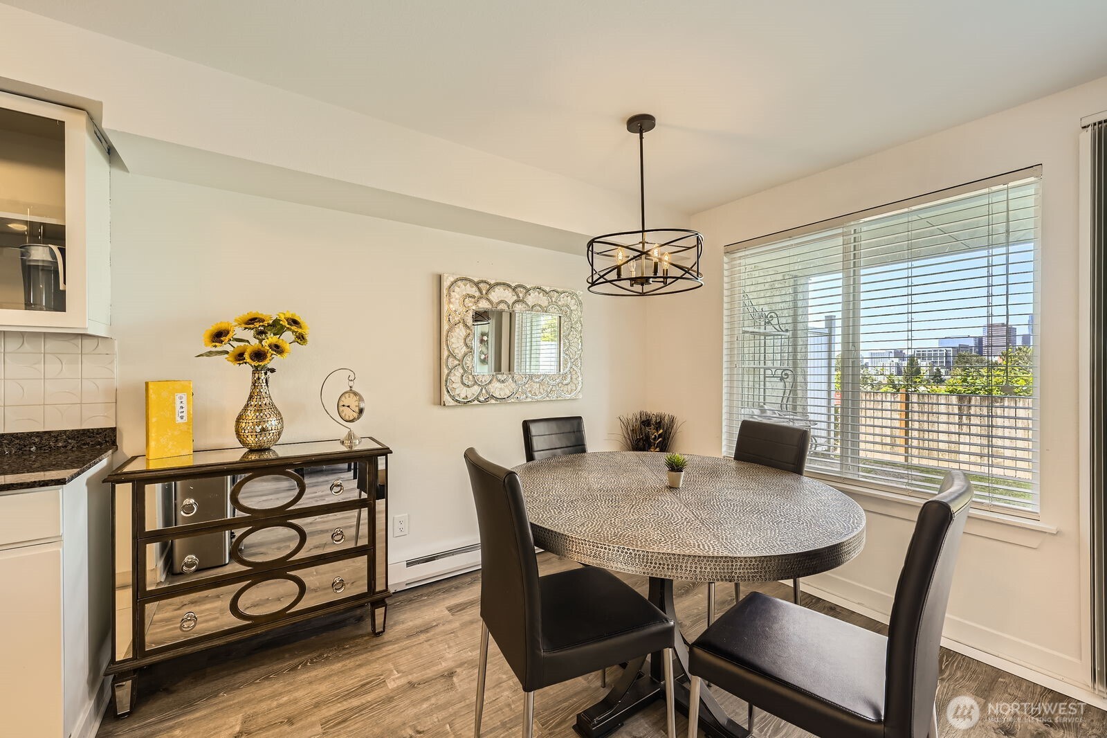 701 122nd Avenue Northeast, Unit 102 Bellevue, WA 98005 - Photo 7 of 14 a view of a dining room with furniture wooden floor and chandelier