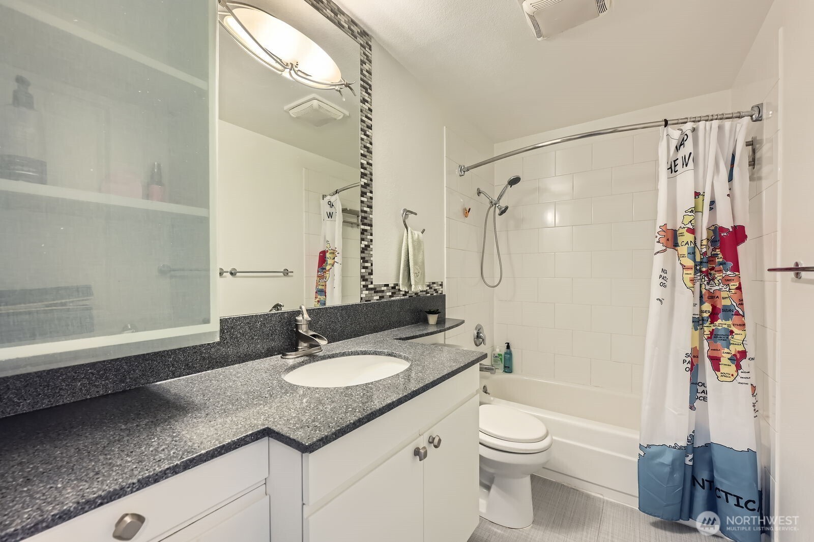 701 122nd Avenue Northeast, Unit 102 Bellevue, WA 98005 - Photo 10 of 14 a bathroom with a granite countertop sink toilet and shower