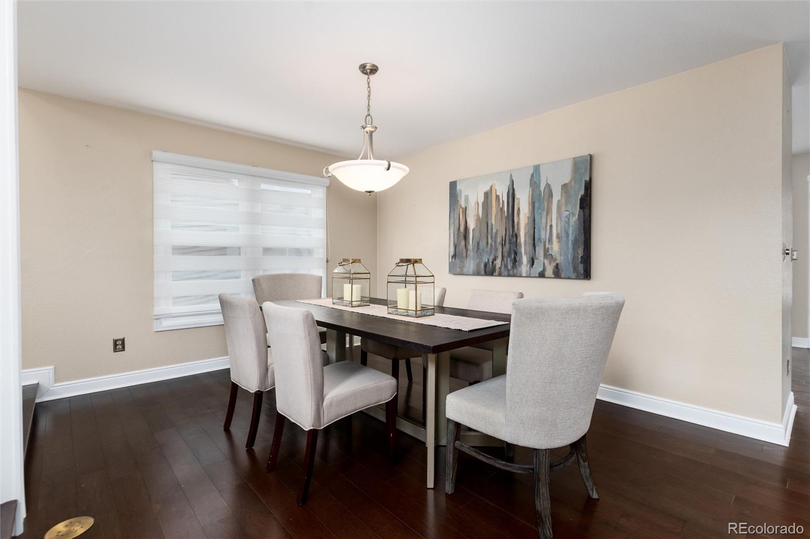 8182 Sweet Water Road Lone Tree, CO 80124 - Photo 8 of 50 a view of a dining room with furniture window and wooden floor