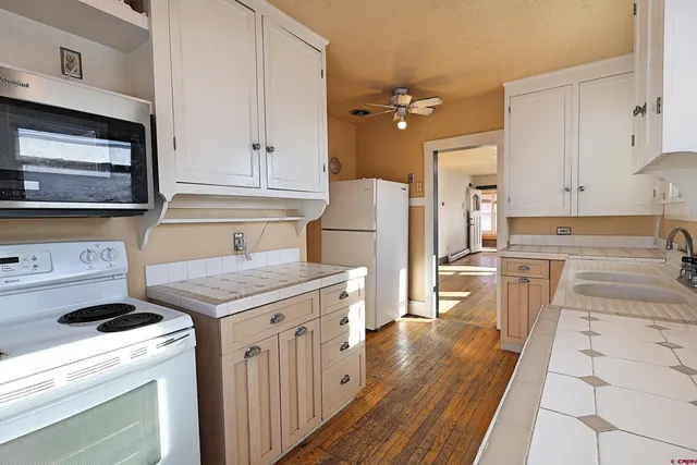 a kitchen with a stove a sink and a refrigerator