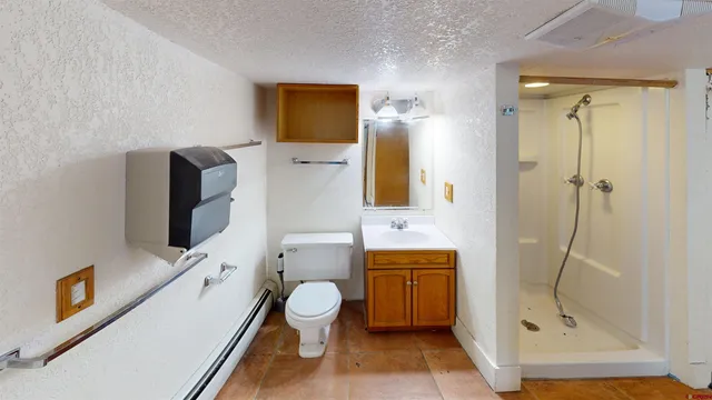 a bathroom with a toilet sink and shower