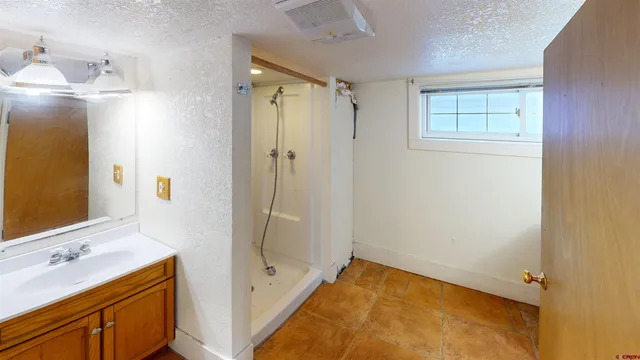a bathroom with a tub sink vanity and mirror