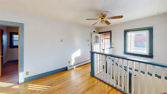 a view of an entryway with wooden floor