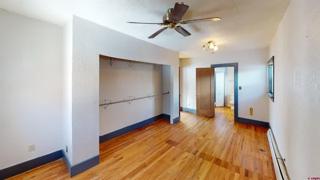 a view of empty room with wooden floor
