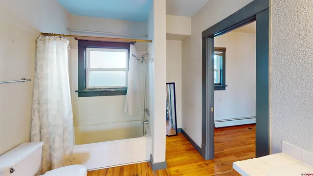 a bathroom with a tub and shower