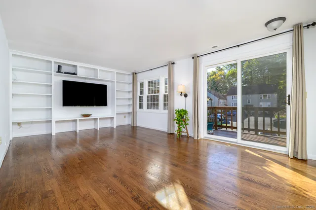 a view of a livingroom with wooden floor and flat screen tv