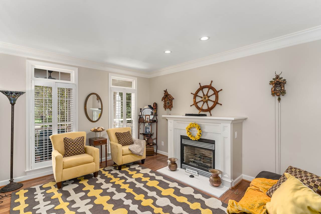 12419 Canolder Street Raleigh, NC 27614 - Photo 4 of 29 Cozy Living Room with fireplace, wood floors and plantation shutters is the perfect spot to enjoy reading a good book on a rainy day. Living Room