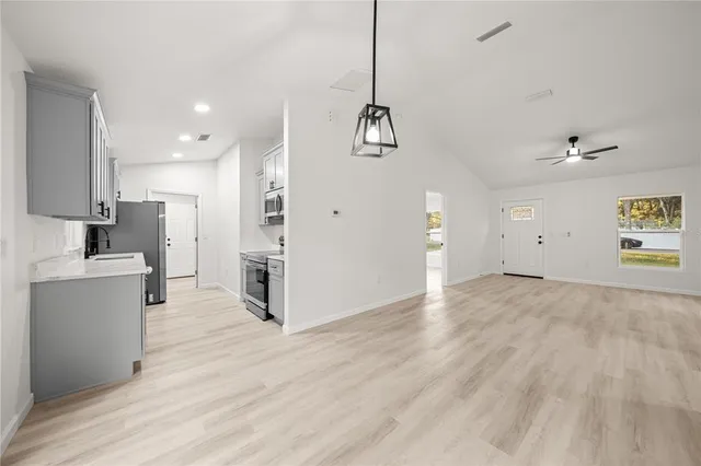 a view of a kitchen with a sink a refrigerator and a stove