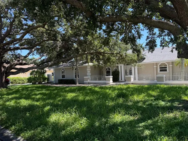 a backyard of a house with table and chairs