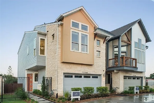 a front view of a residential apartment building with a yard