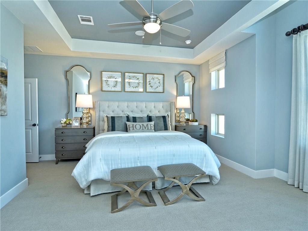 12504 Red Sparrow Street, Unit 1 Austin, TX 78729 - Photo 14 of 22 a bedroom with a bed mirror and a window