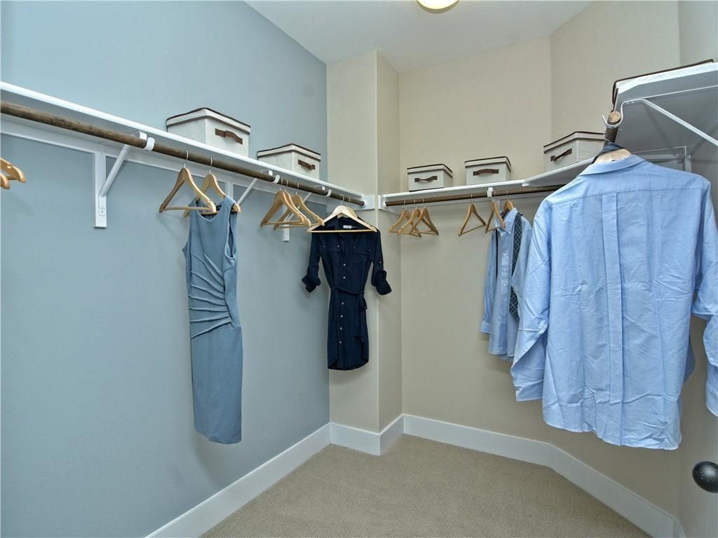 12504 Red Sparrow Street, Unit 1 Austin, TX 78729 - Photo 17 of 22 a view of walk in closet with clothes and shoes