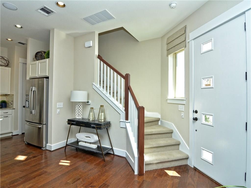 12504 Red Sparrow Street, Unit 1 Austin, TX 78729 - Photo 2 of 22 a view of entryway with wooden floor and stairs