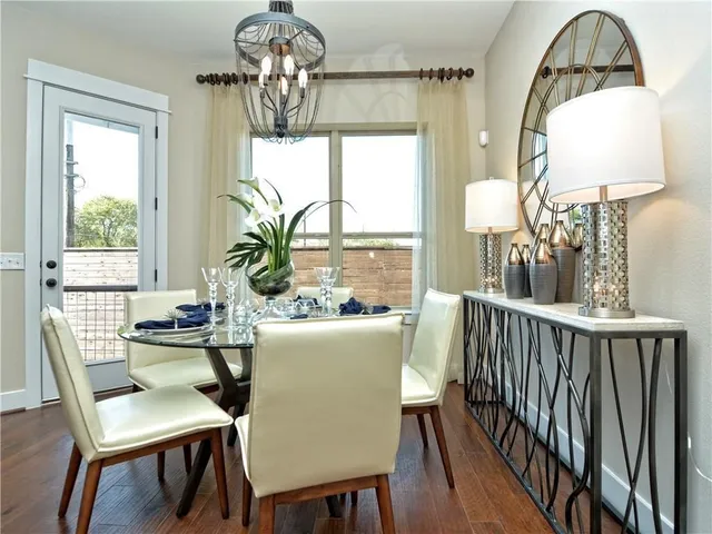 a dining room with furniture a chandelier and wooden floor