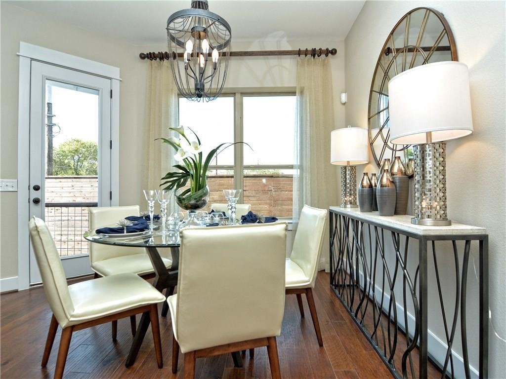 12504 Red Sparrow Street, Unit 1 Austin, TX 78729 - Photo 6 of 22 a dining room with furniture a chandelier and wooden floor